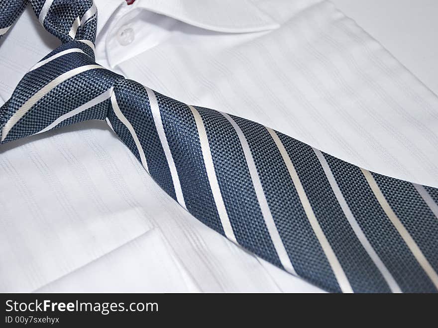 Striped necktie with unit closeup on the white shirt. Striped necktie with unit closeup on the white shirt