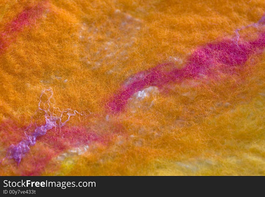 Colorful felted wool on silk texture close-up background. Colorful felted wool on silk texture close-up background