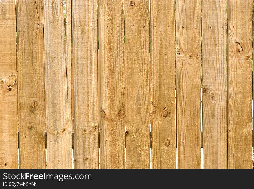 A new fence of rough pine planks. A new fence of rough pine planks