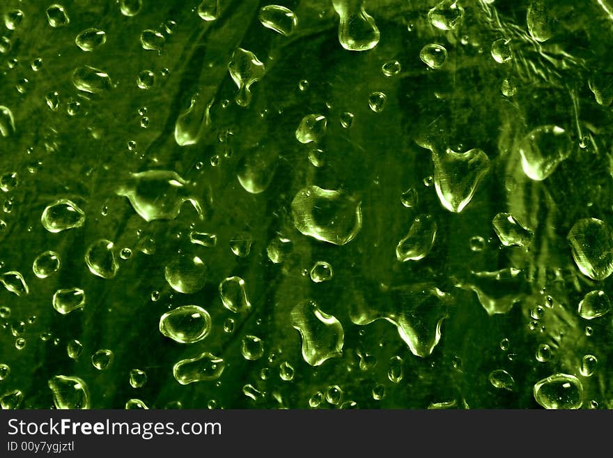 A lot of drops on green background