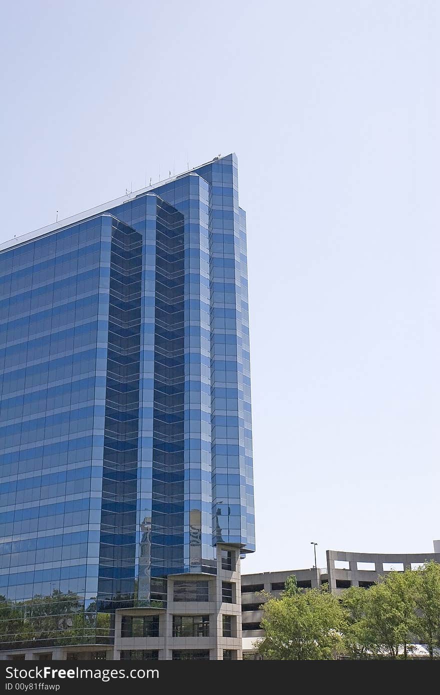 A modern glass office tower in three shades of blue. A modern glass office tower in three shades of blue