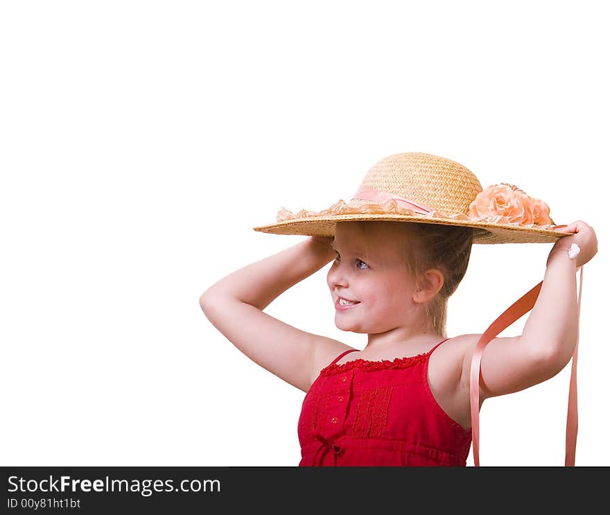 A little girl in a red dress posing with a big straw hat. A little girl in a red dress posing with a big straw hat