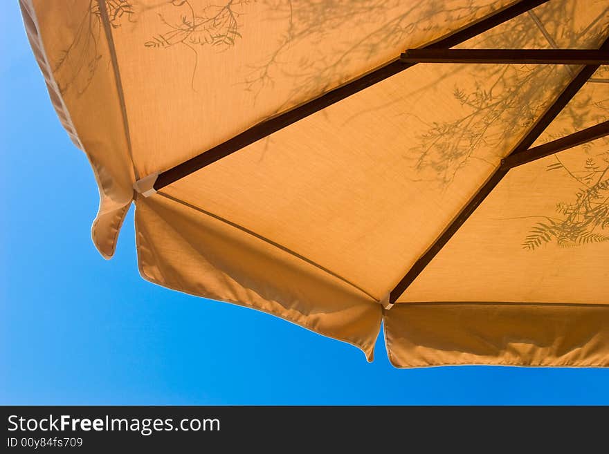 Sunshade with foliage shadows at sunny summer day. Sunshade with foliage shadows at sunny summer day