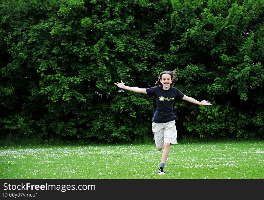 Girl running with arms outstretched