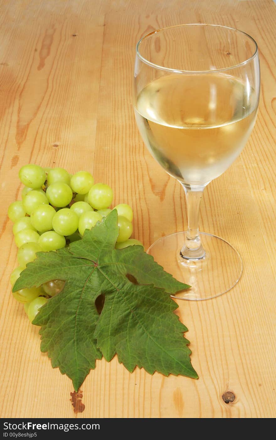 Glass of white wine with a bunch of grapes. Glass of white wine with a bunch of grapes