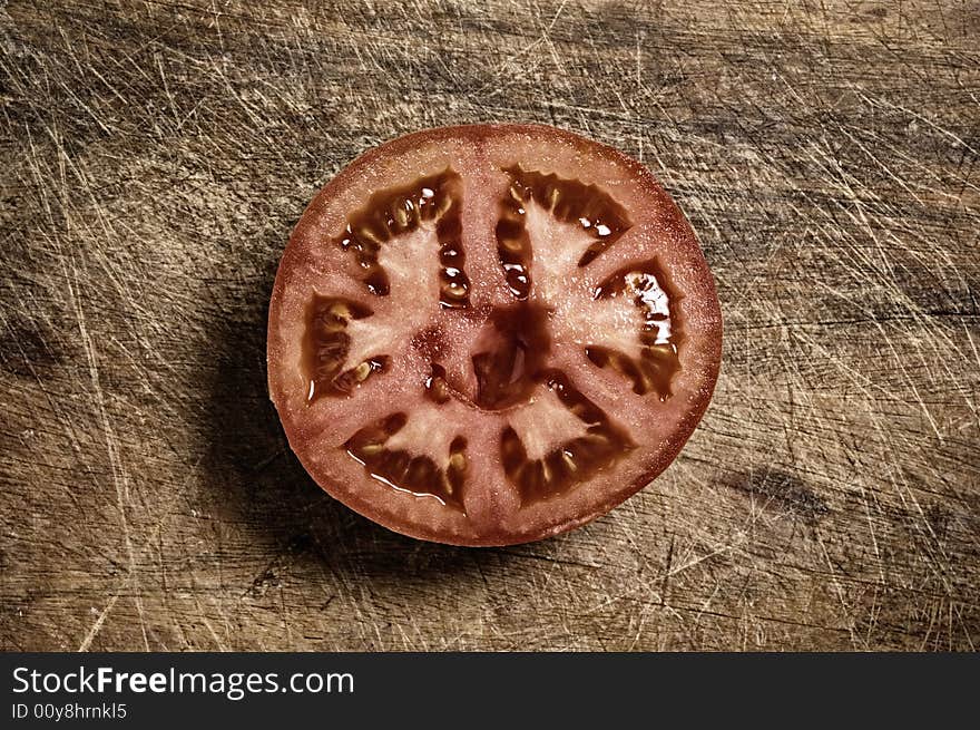 Tomato on wooden cutting table. Tomato on wooden cutting table.