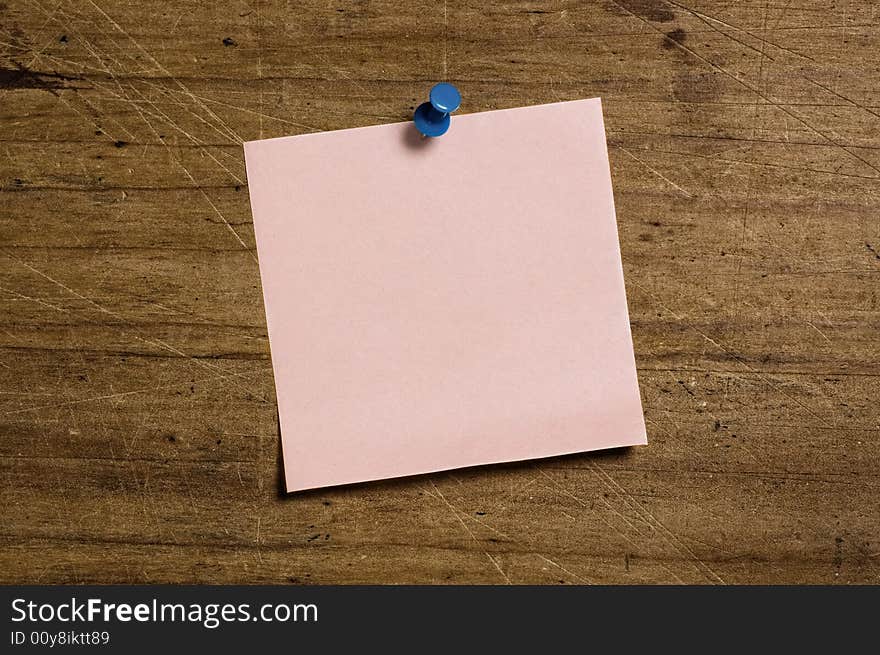 Note with Tack on wooden board. Note with Tack on wooden board.