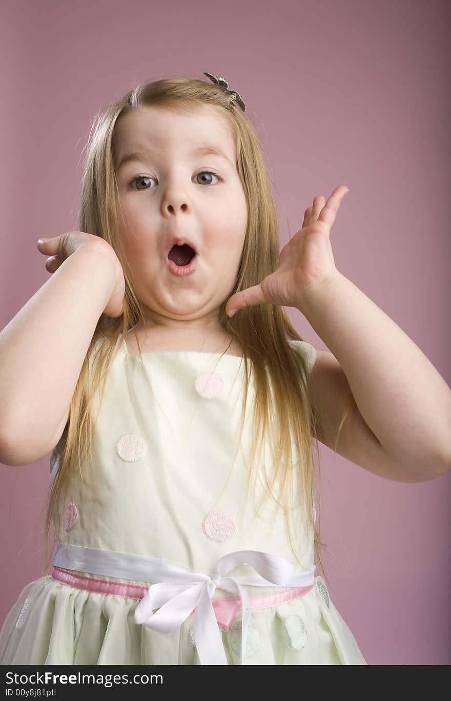 Taken Aback little girl on pink background. Taken Aback little girl on pink background