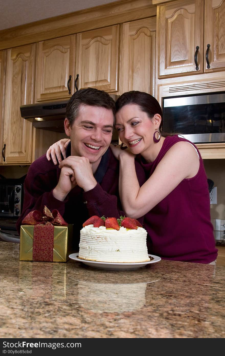 Couple Exchanging Gifts in the Kitchen - Vertical