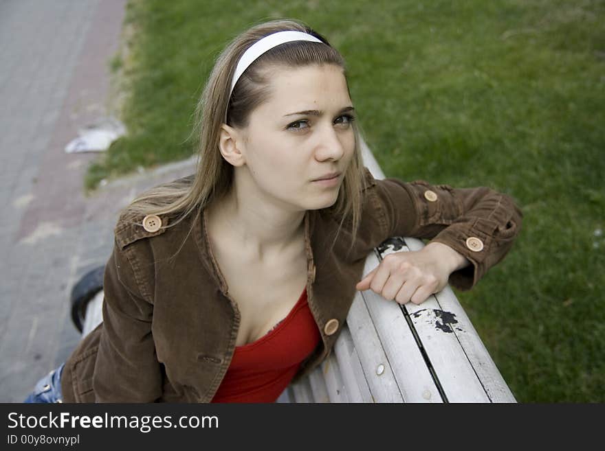 Girl on bench in town. Girl on bench in town