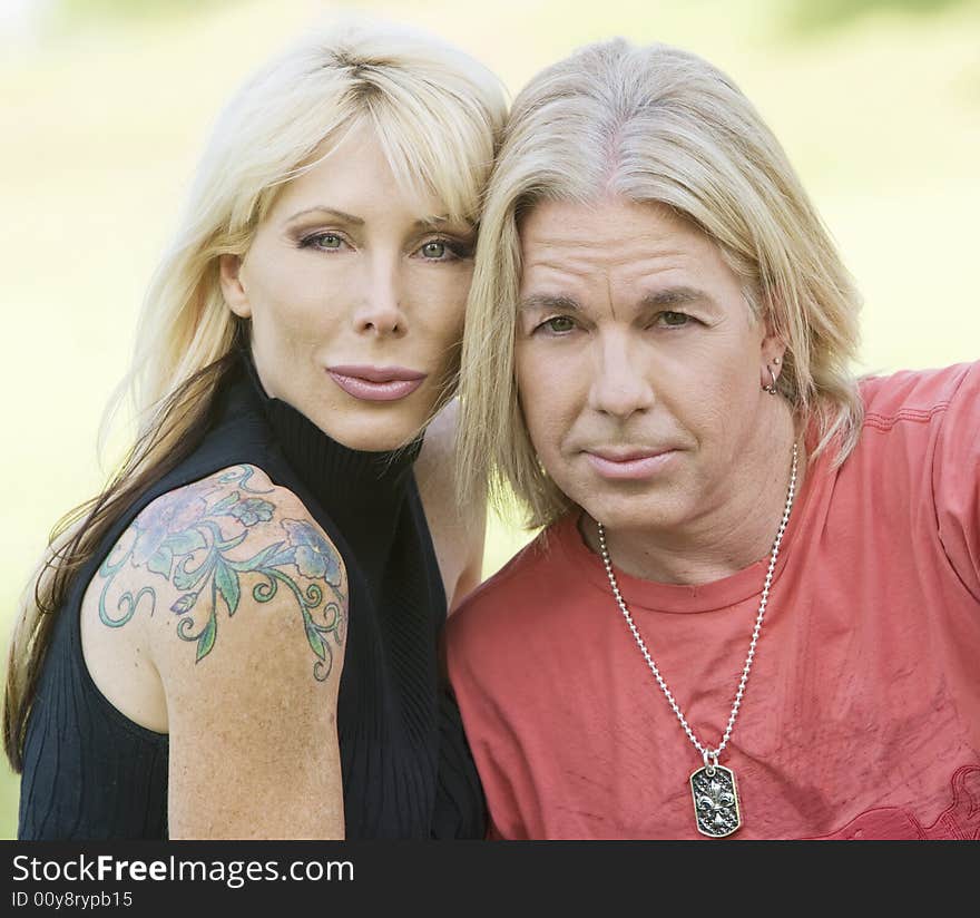 Outdoor portrait of a hip man and woman. Outdoor portrait of a hip man and woman