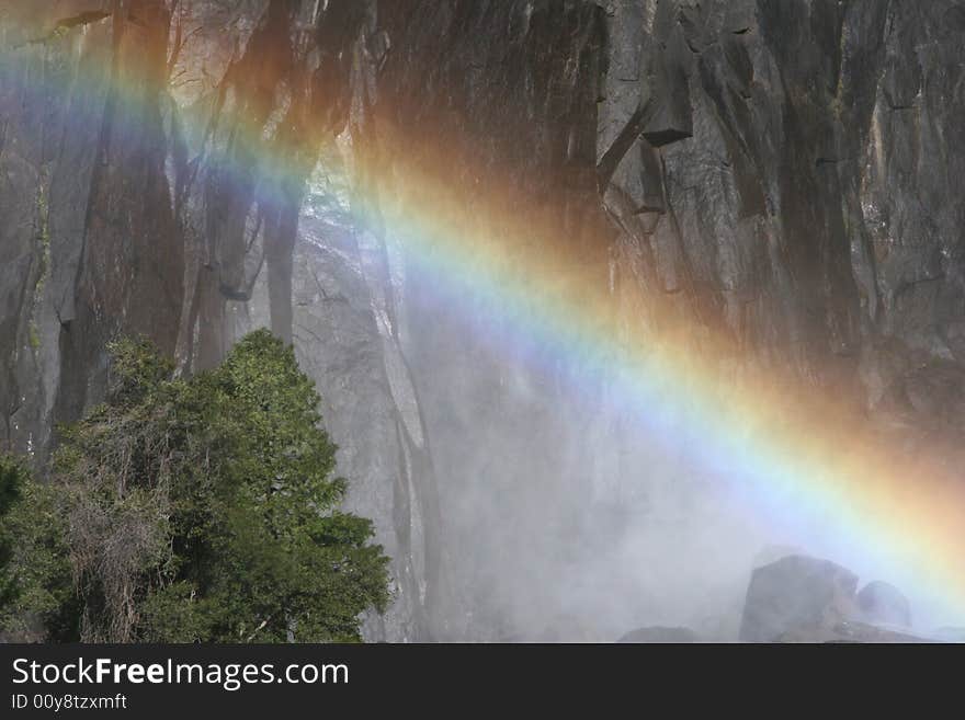 Colorful rainbow over the famous natural landmark Yosemite fall. Yosemite national park. California. USA