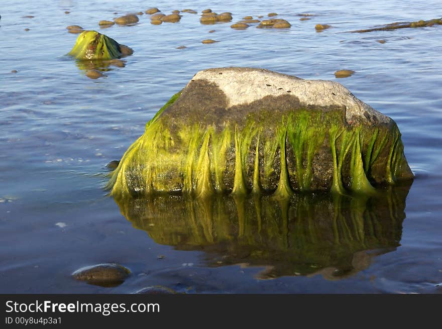 Green Colored Stones in Blue Sea