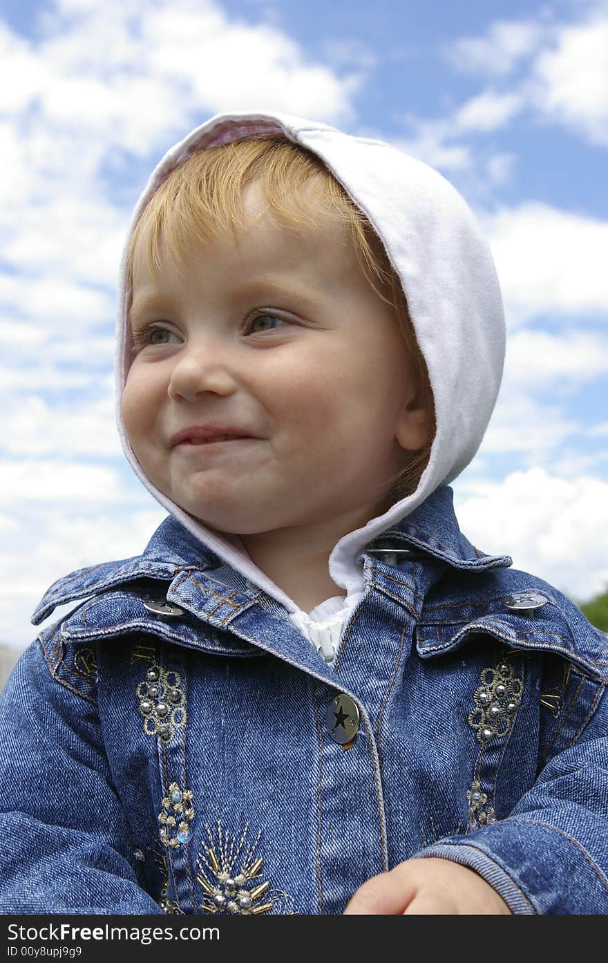 The clever little girl on a background of the sky. The clever little girl on a background of the sky