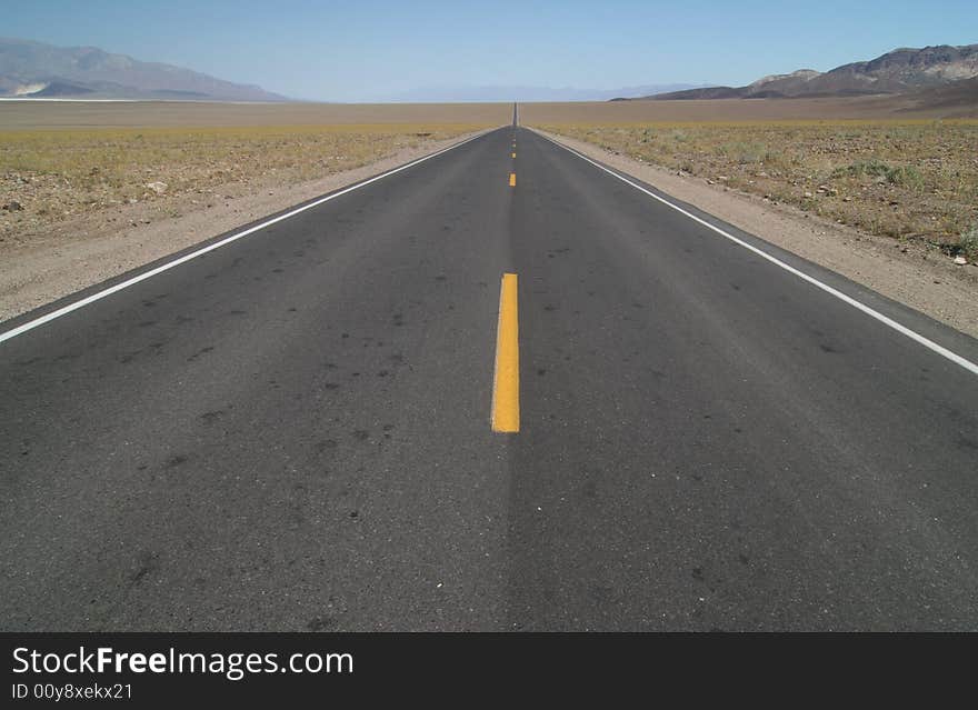 Road leading through famous natural landmark Death Valley. Death Valley national park. California. USA. Road leading through famous natural landmark Death Valley. Death Valley national park. California. USA