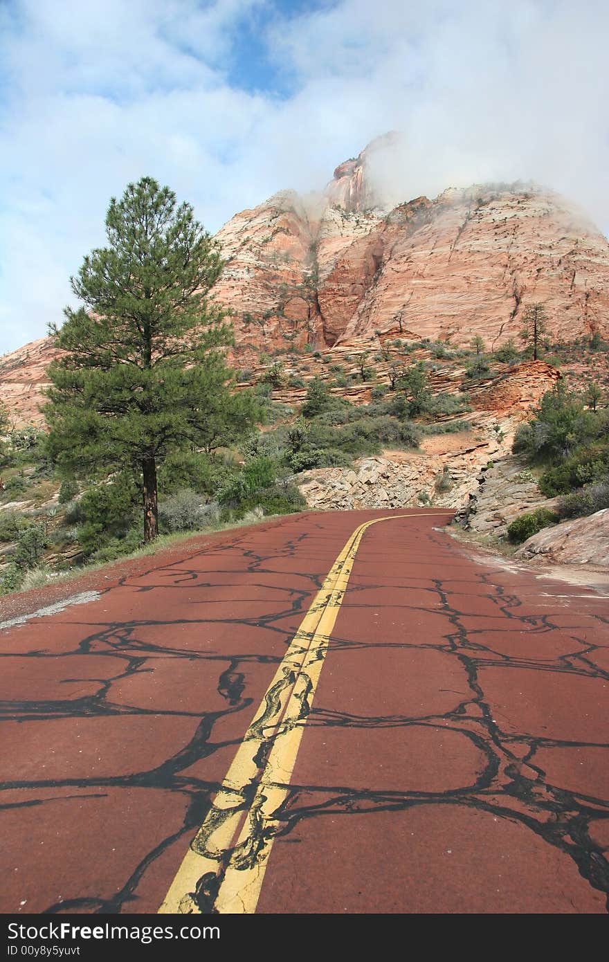 Red road leading to the mountains of the Zion National Park. Utah. USA. Red road leading to the mountains of the Zion National Park. Utah. USA