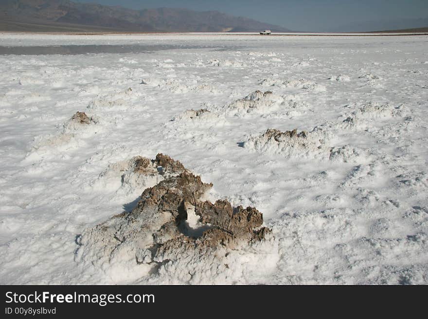 Four wheel drive truck crossing the Badwater Basin in Death valley. Death Valley national park. California. USA