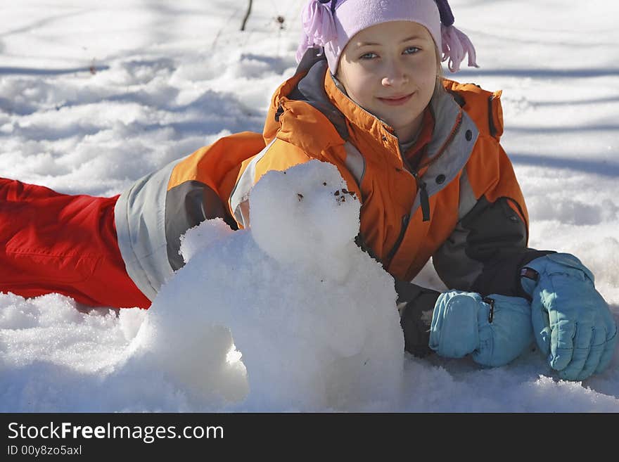 A girl with a dog modelled out of snow. A girl with a dog modelled out of snow.