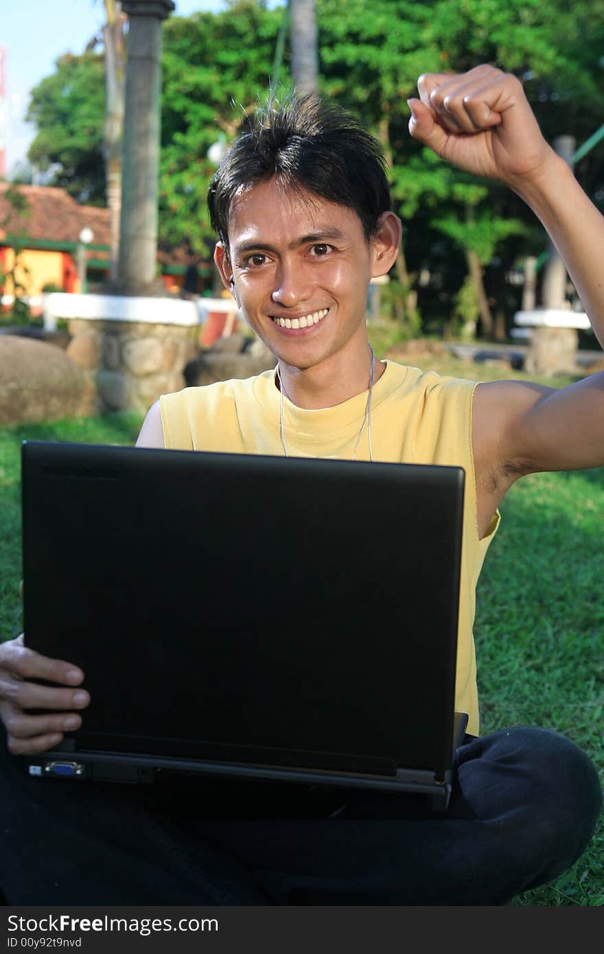 Casual man happy on laptop