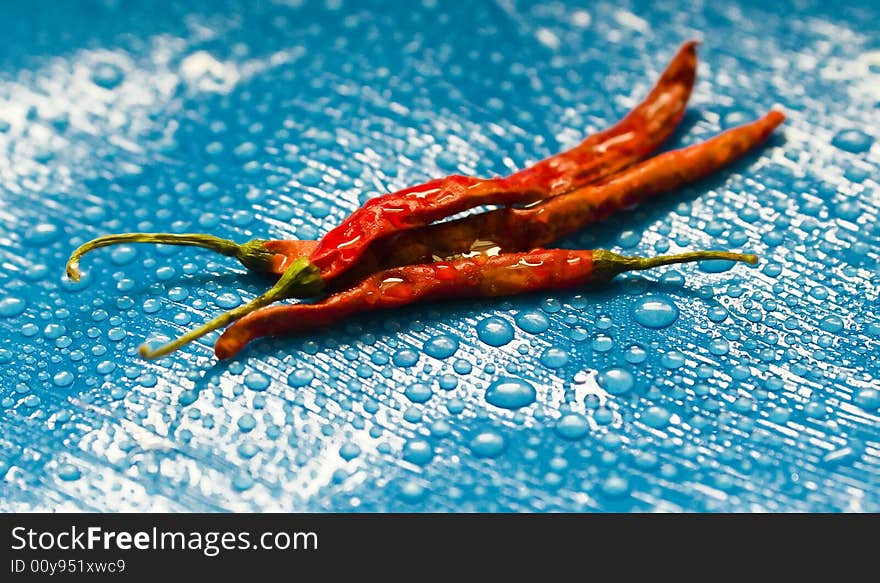 Dried red chili peppers and water drops.