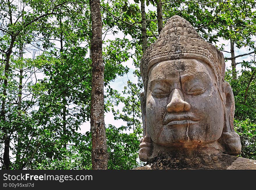 Cambodia the doors of Angkor Thom. View of an impressive stone statue of a a face with khmer features.