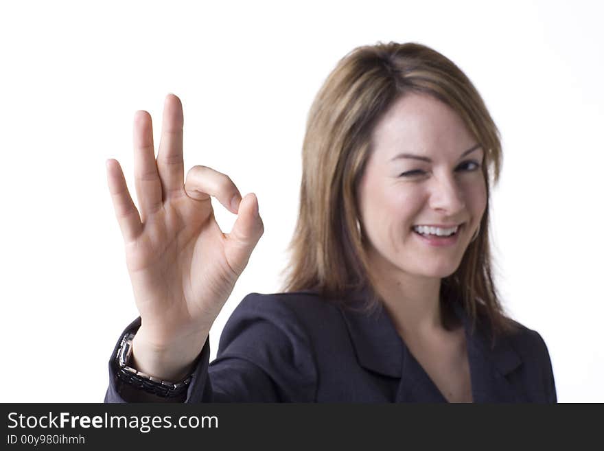 Businesswoman giving the OK sign isolated on white with studio lighting