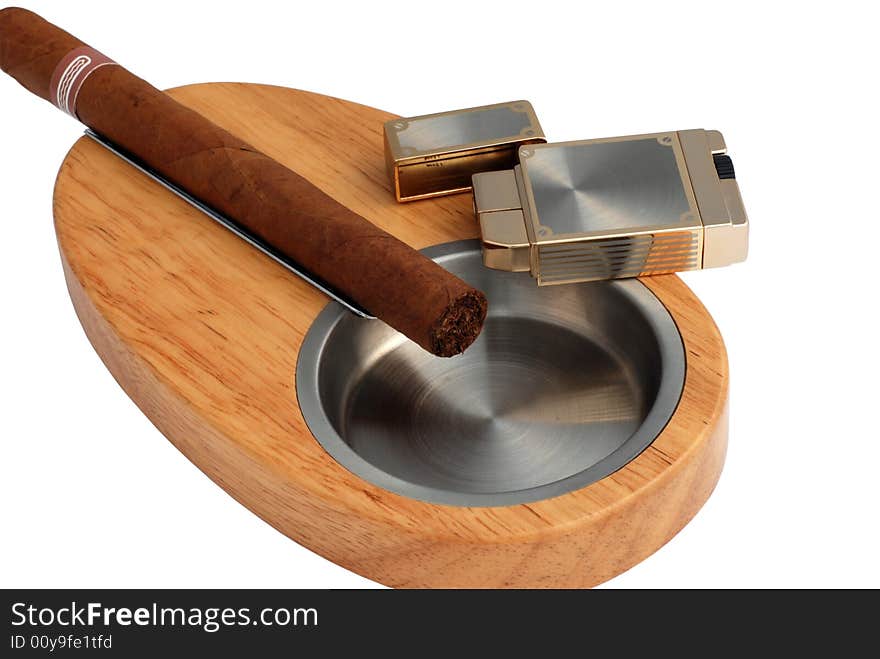 Close up of stylish elegant wood and metallic ashtray, lighter and cuban cigar