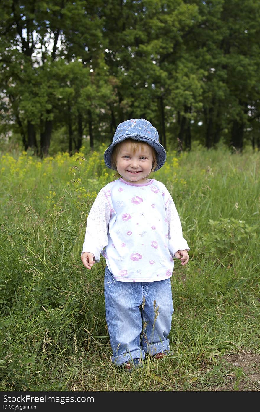 Cute little girl on a background of a landscape