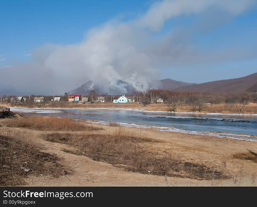 A big forest fire behind a village. Russian Far East, Primorye, Sokolovka village. A big forest fire behind a village. Russian Far East, Primorye, Sokolovka village.