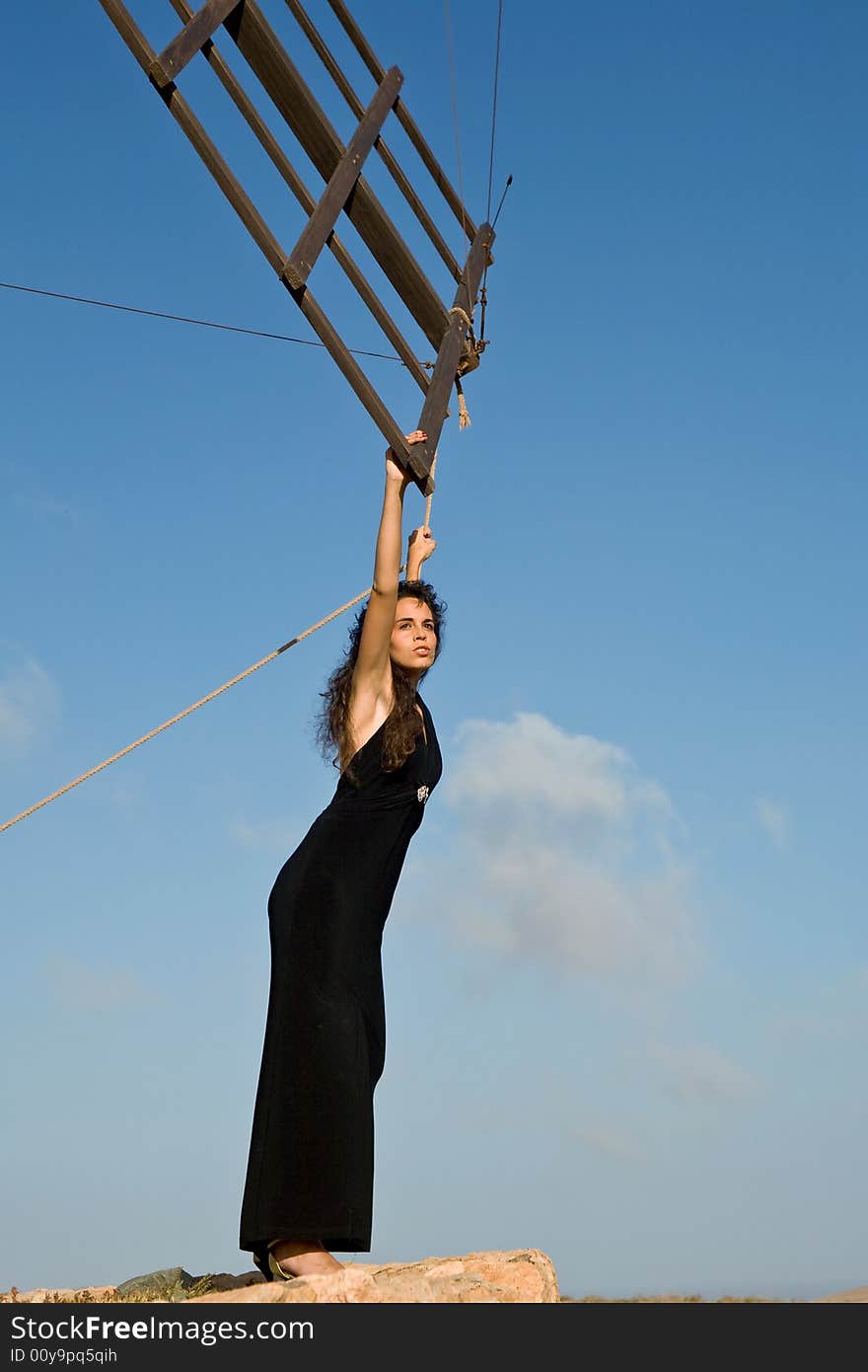 Young fashion model on a desert landscape under blue sky. Young fashion model on a desert landscape under blue sky