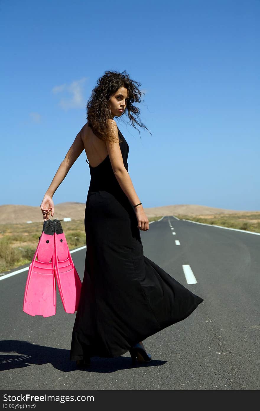 Young fashion model on a desert landscape under blue sky. Young fashion model on a desert landscape under blue sky