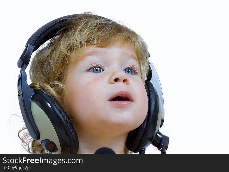 Portrait of young baby  listening music via phones. Portrait of young baby  listening music via phones