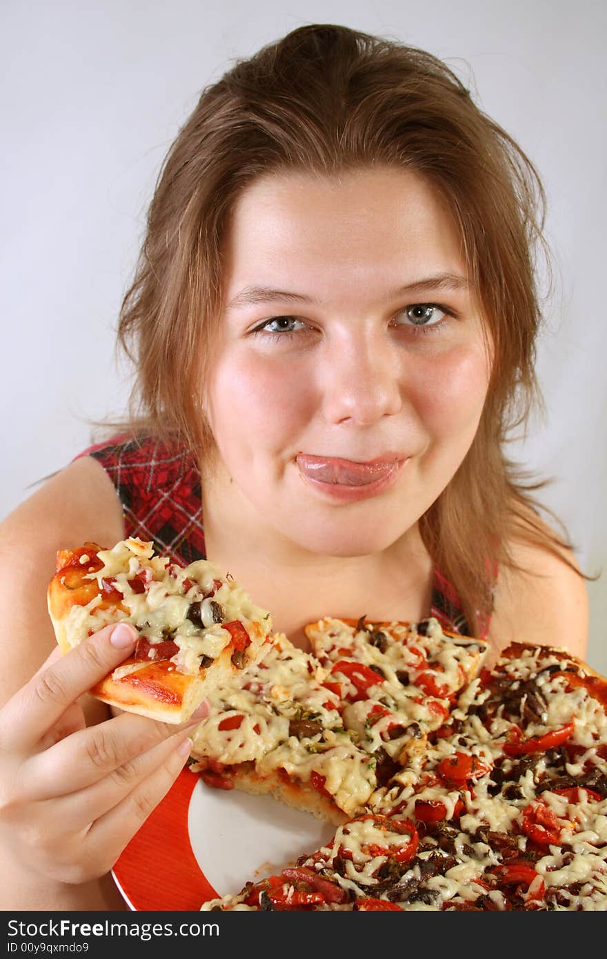 Beautiful no make-up girl eating a piece of Pizza. Beautiful no make-up girl eating a piece of Pizza