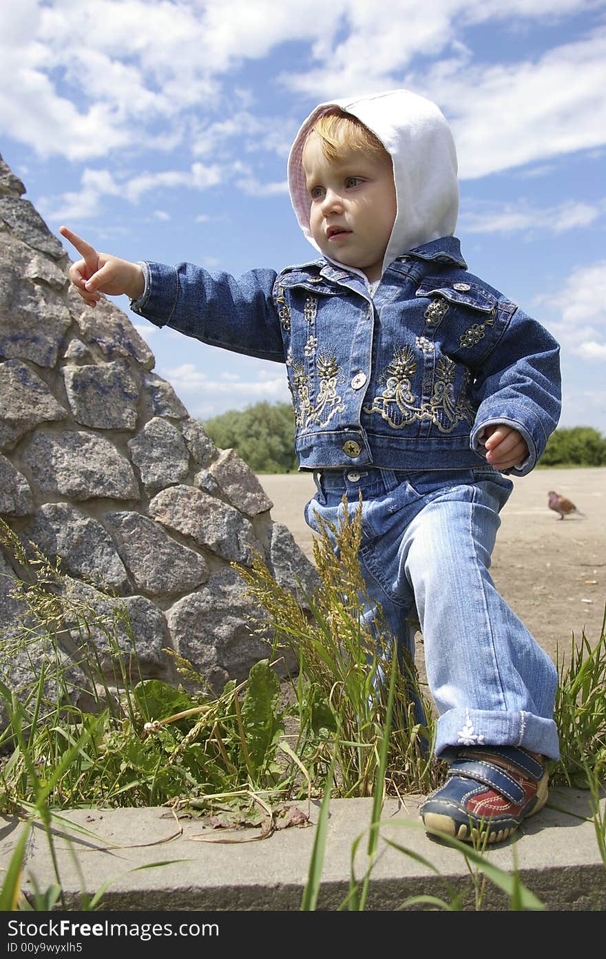 The clever little girl on a background of the sky. The clever little girl on a background of the sky