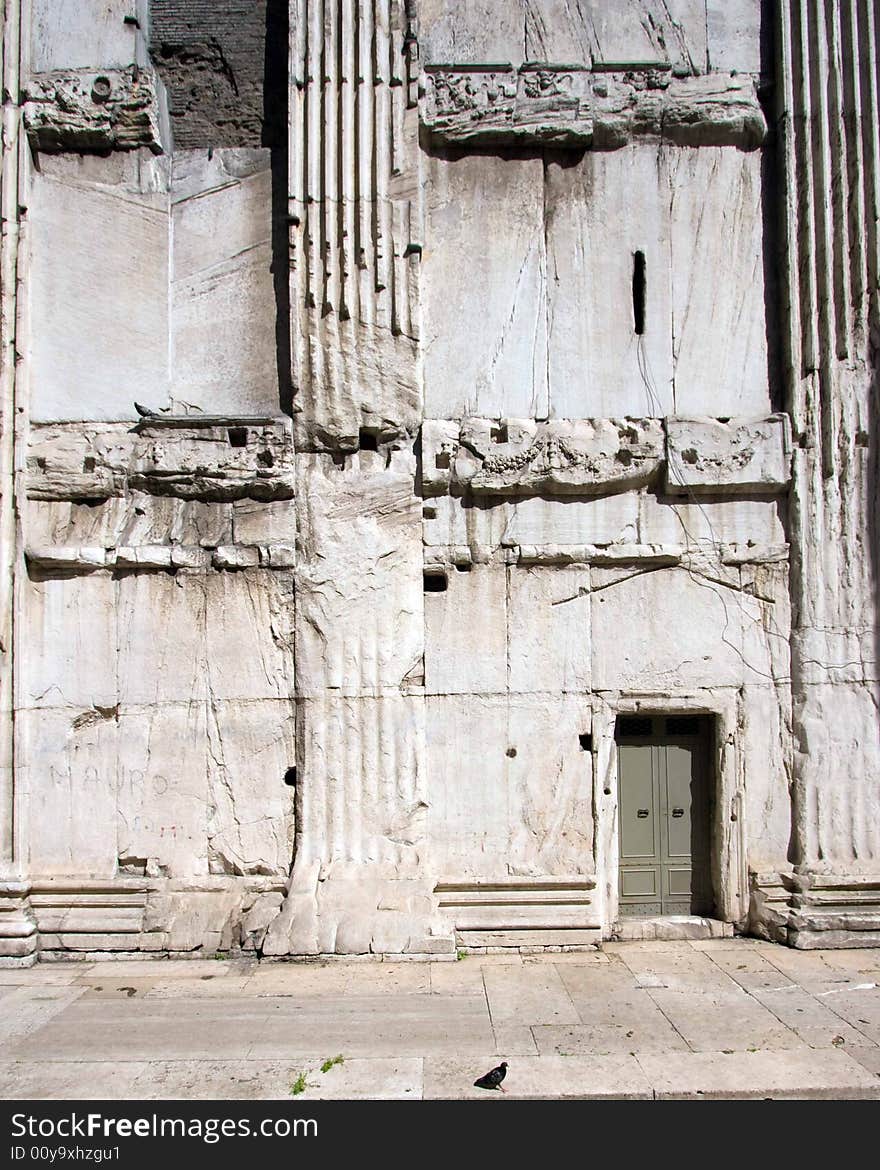 Small door in a massive wall in an ancient building; Rome, Italy