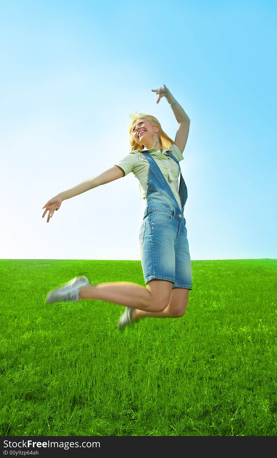 Beauty young woman jump in field