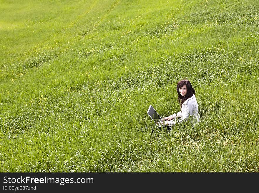 Woman connected on the grass