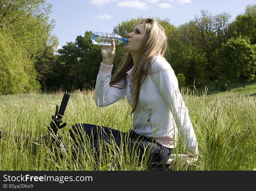 Girl drinking water after doing sport