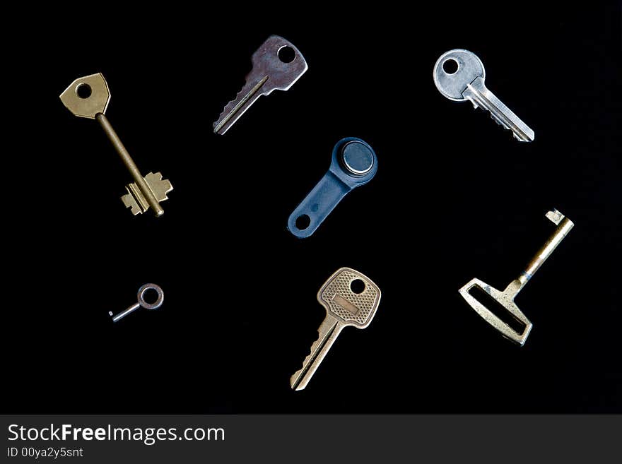 Keys from different locks isolated on a black background