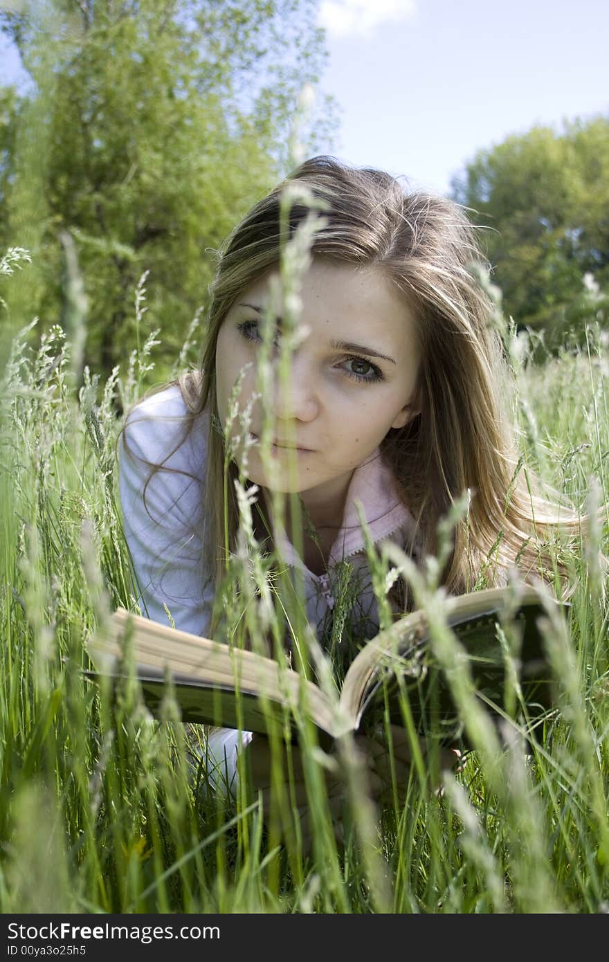 Girl reading a book outdoor