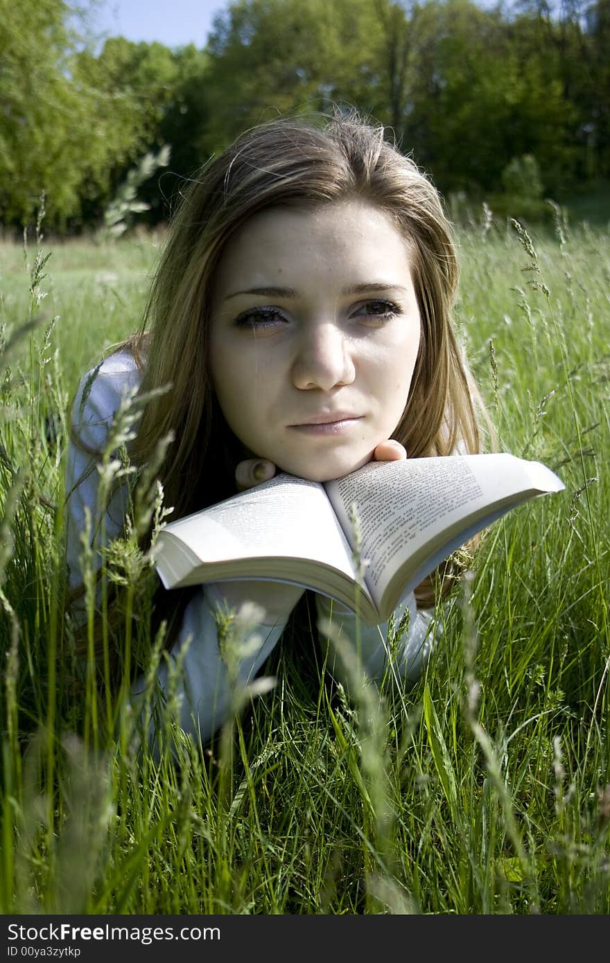 Girl reading a book outdoor