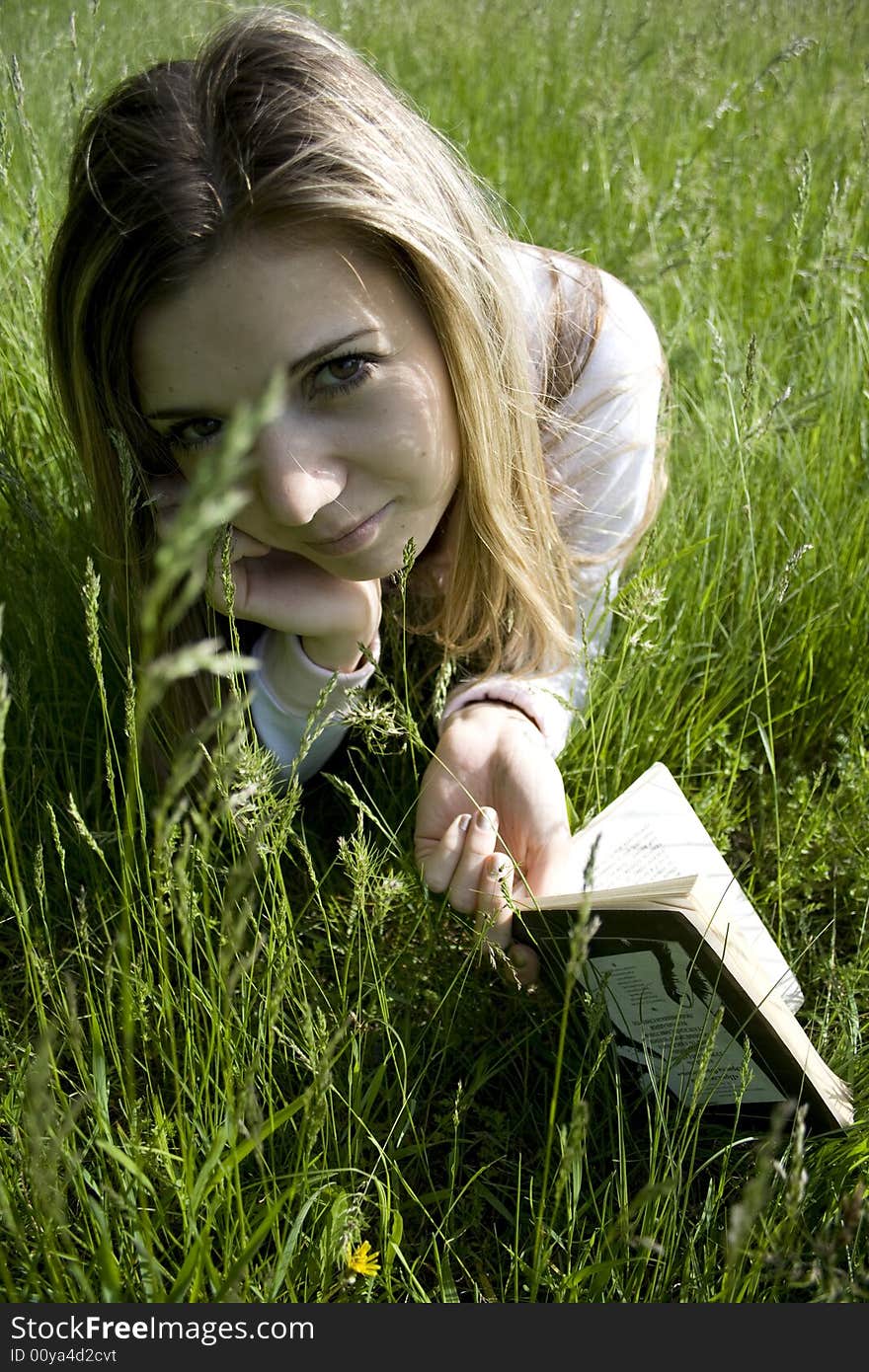 Girl read book on meadow. Girl read book on meadow