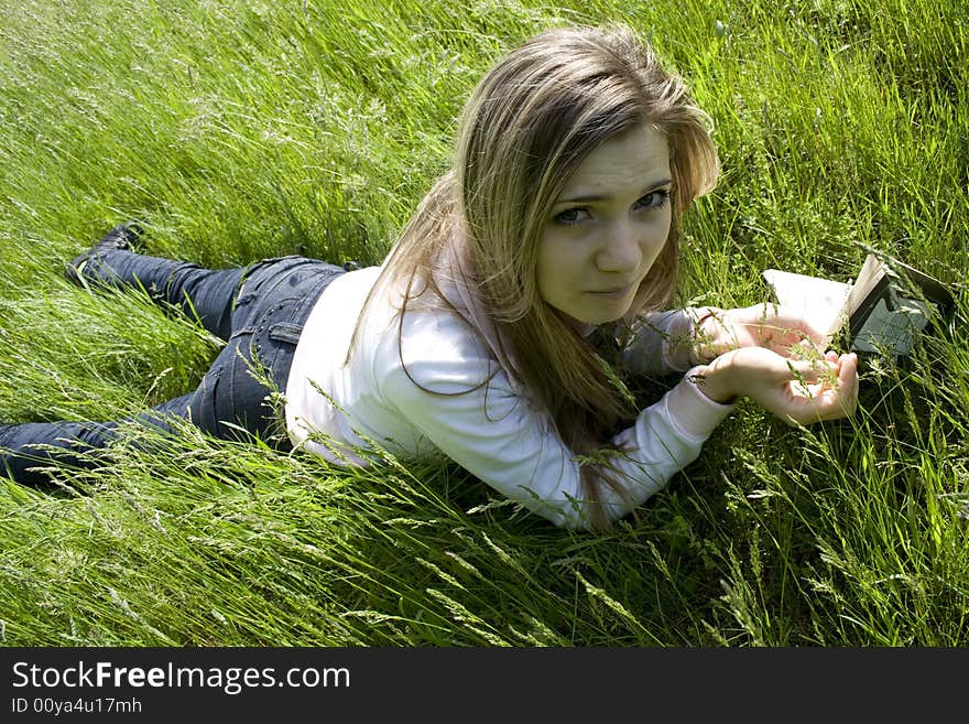 Girl read book on meadow. Girl read book on meadow