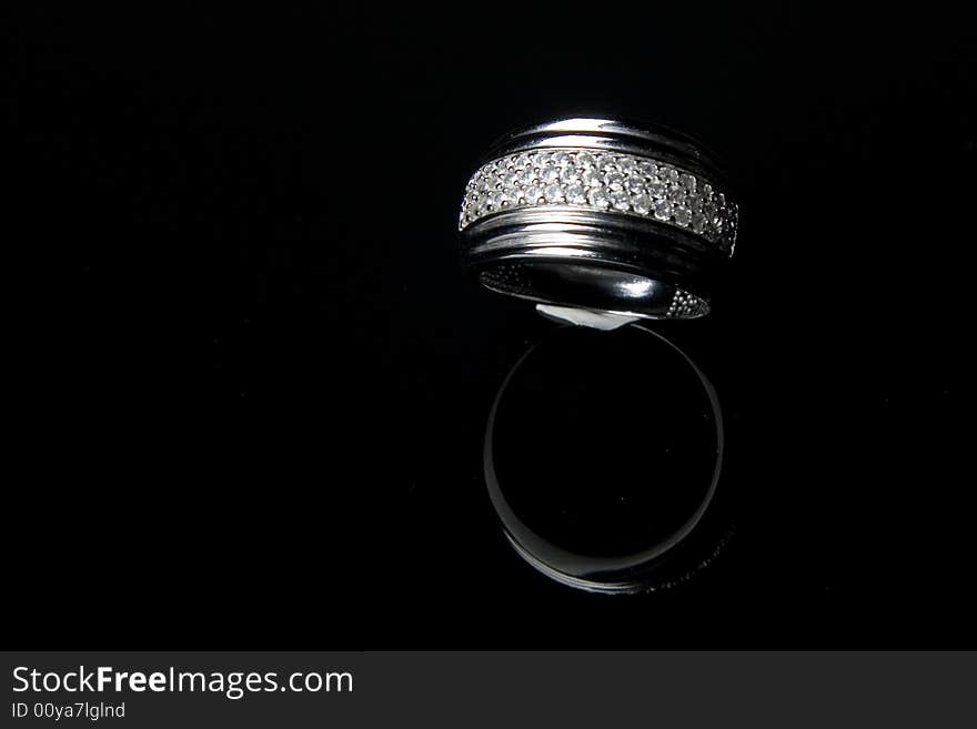 Diamond ring with reflection in isolated black bac