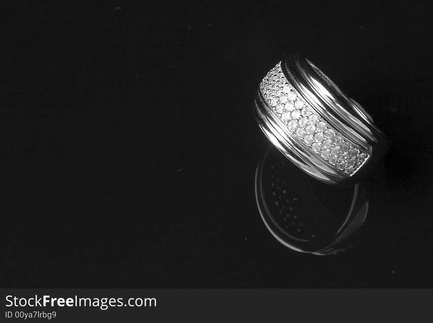 Diamond ring with reflection in isolated black bac