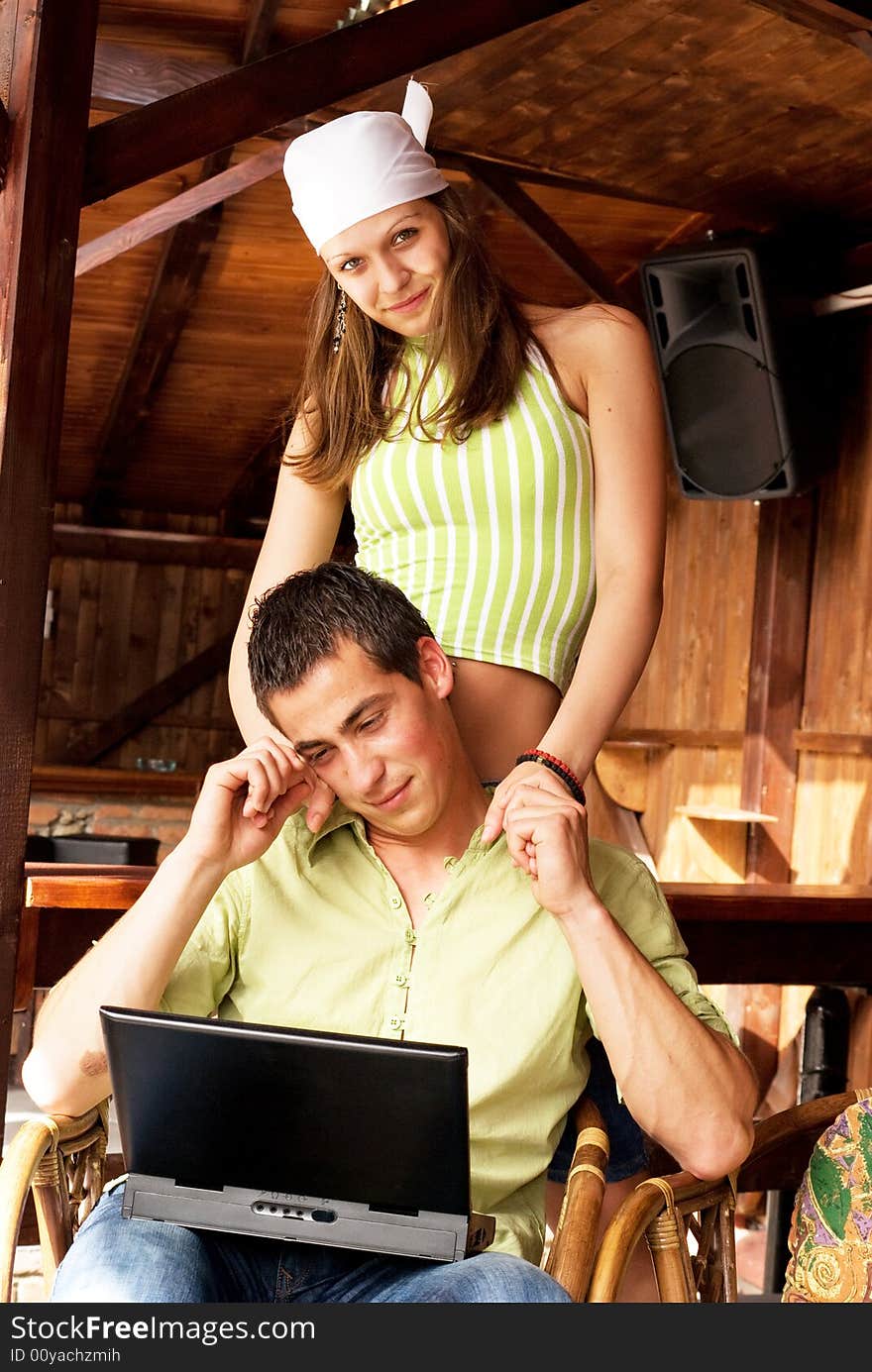 Young man and woman in restaurant with laptop. Young man and woman in restaurant with laptop