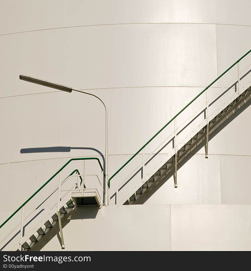 Industrial staircase with lamp at the big gas container