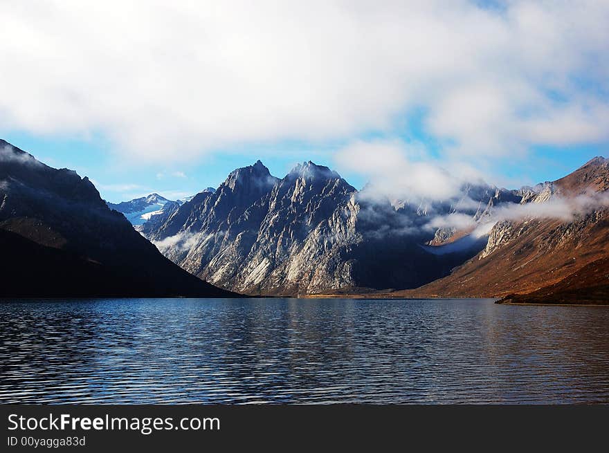 When travelling in Tibet of China, a beautiful lake beyond a mountain appears in front of us. . When travelling in Tibet of China, a beautiful lake beyond a mountain appears in front of us.