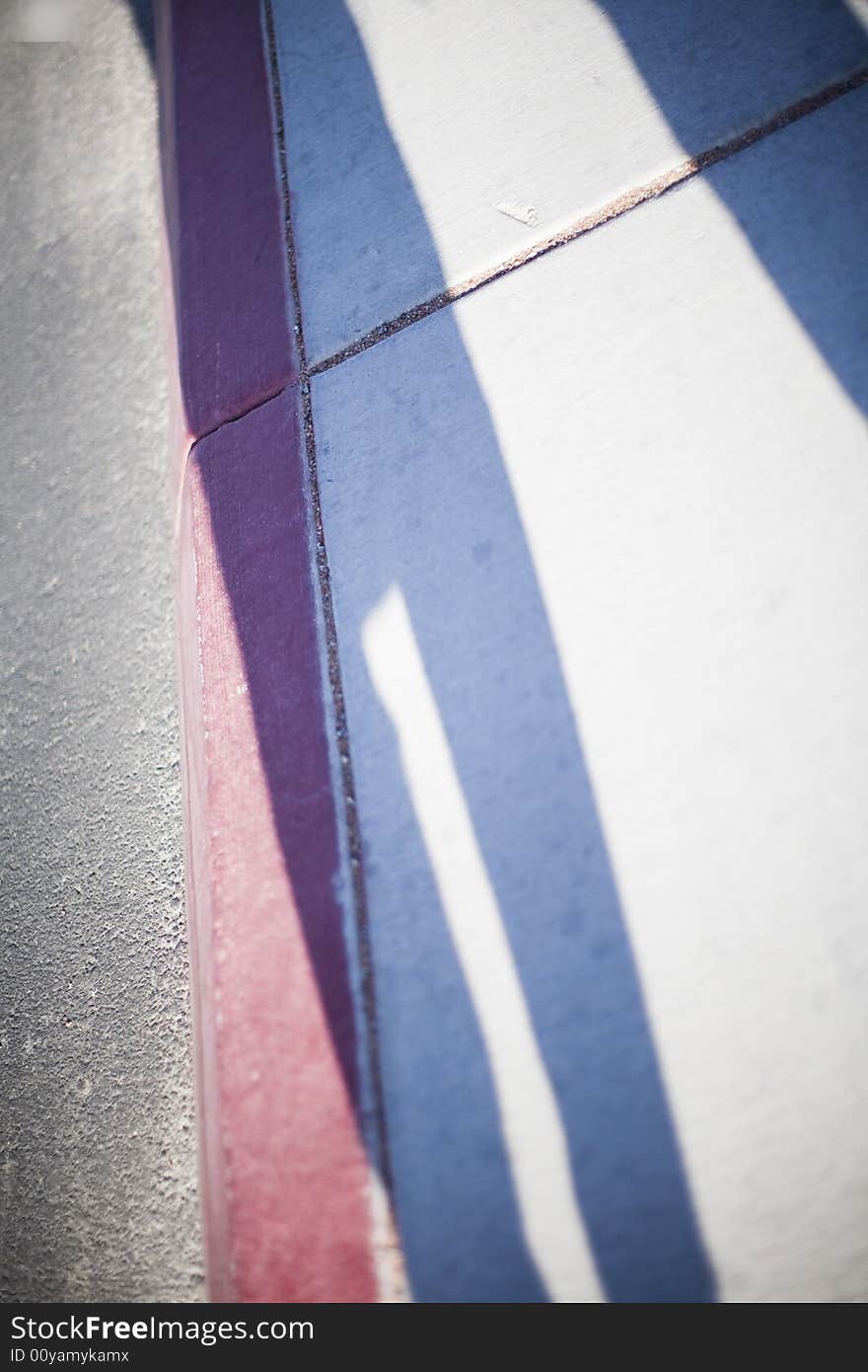 Empty sidewalk with shadows of people near pavement