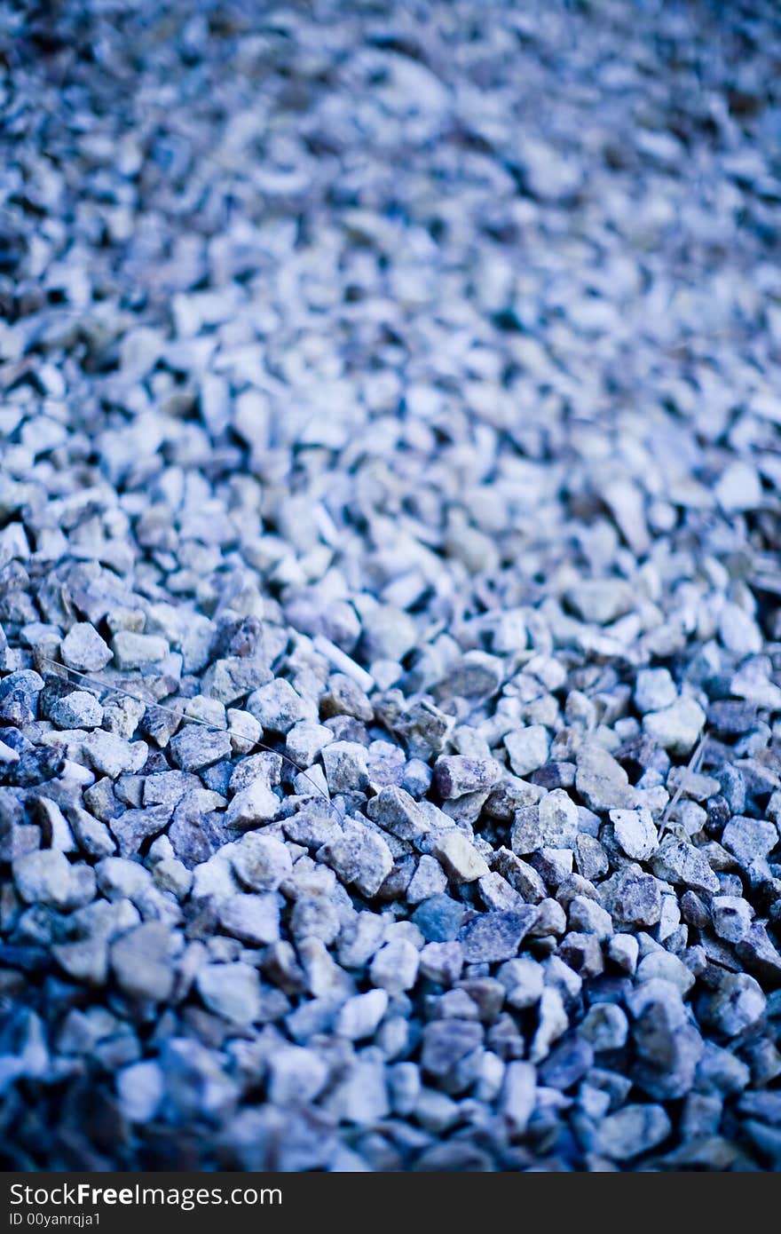 Small rocks are lined together to form a landscape of similar rocks and stones